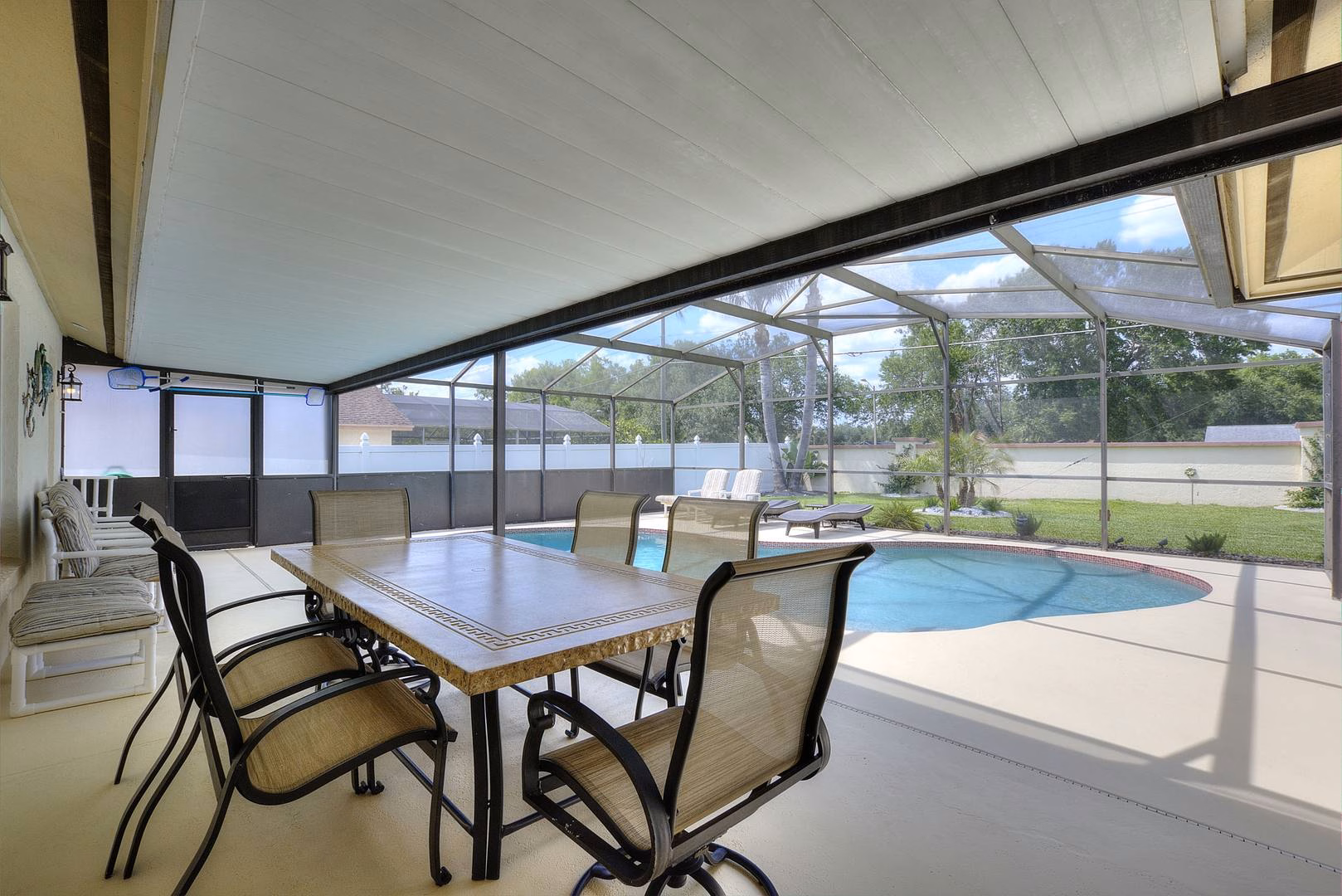 Covered lanai dining overlooking the pool