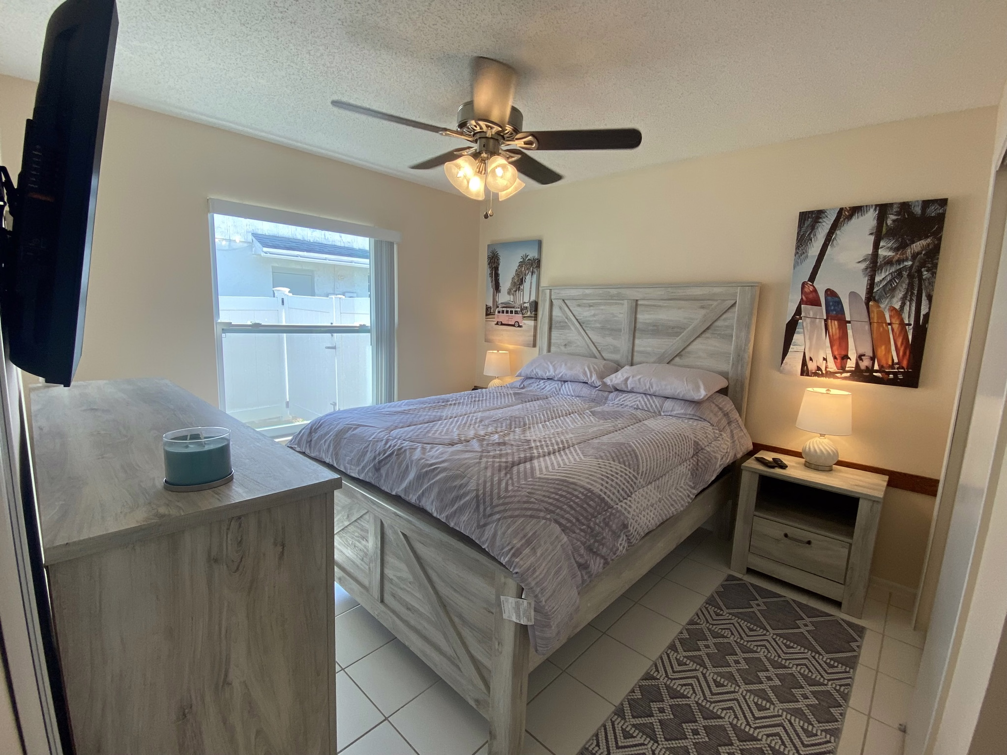 Queen bedroom with dresser and TV