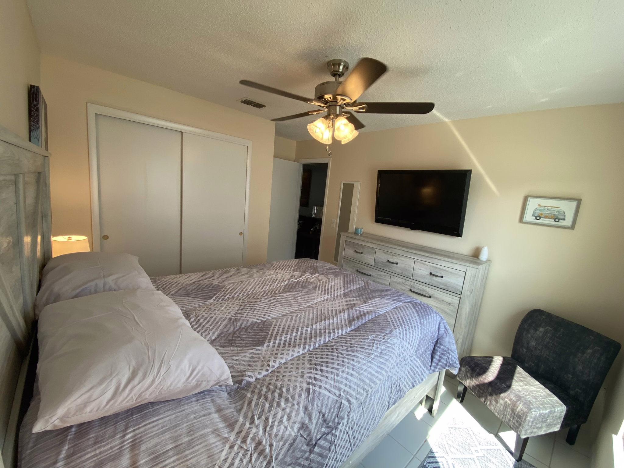 Queen bed with wall-mounted TV